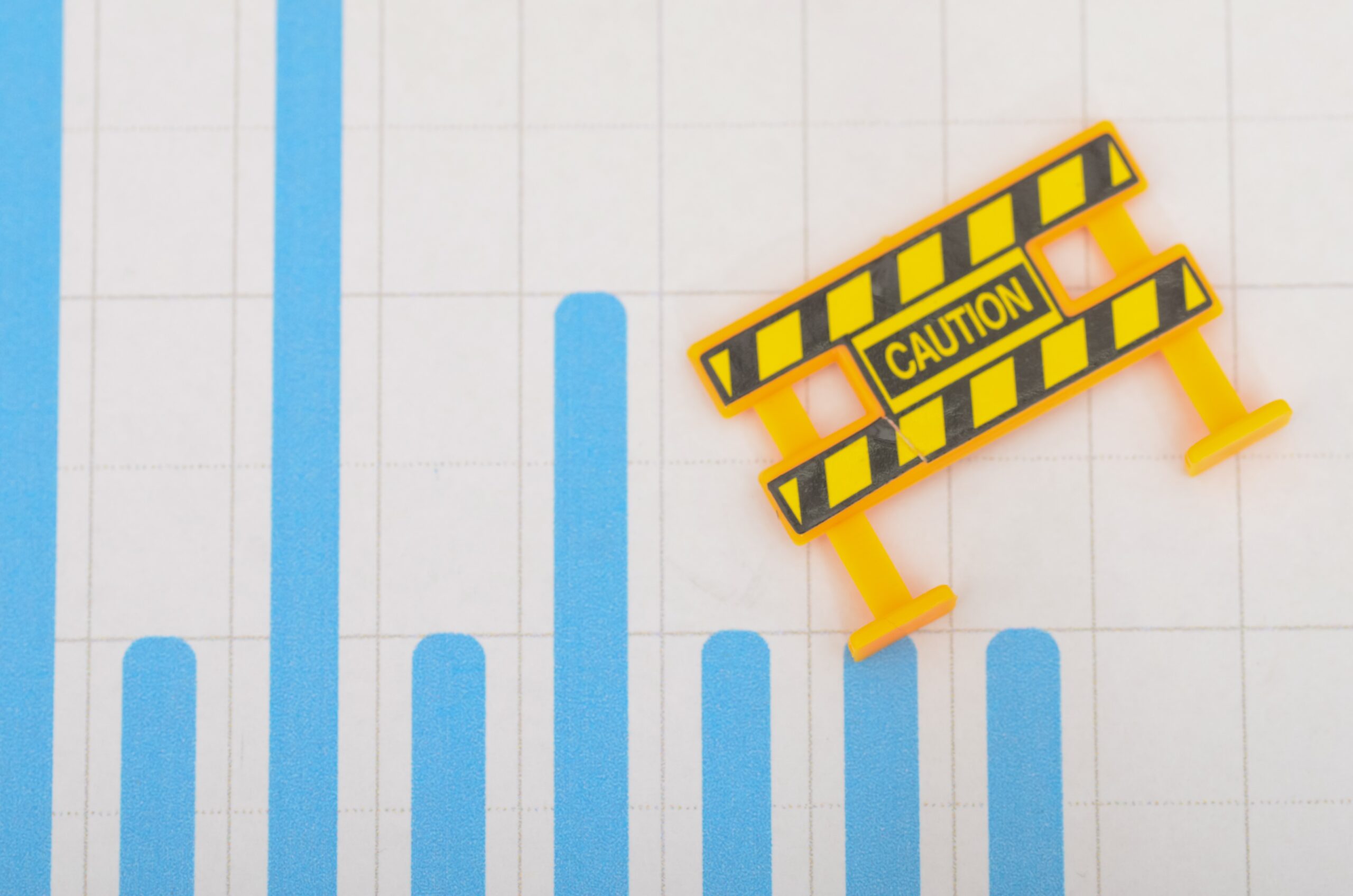 Caution Barrier Across Bar Graph – Risk Alert and Financial Warning Concept on White Grid