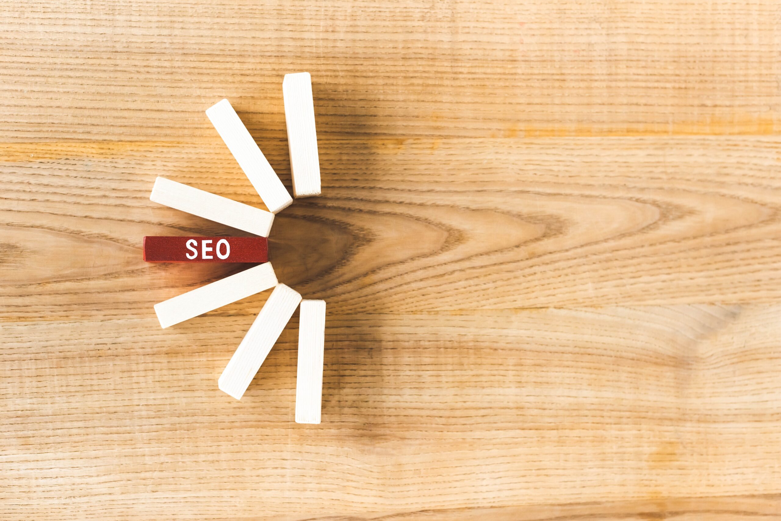 top view of wooden rectangles with lettering seo on table